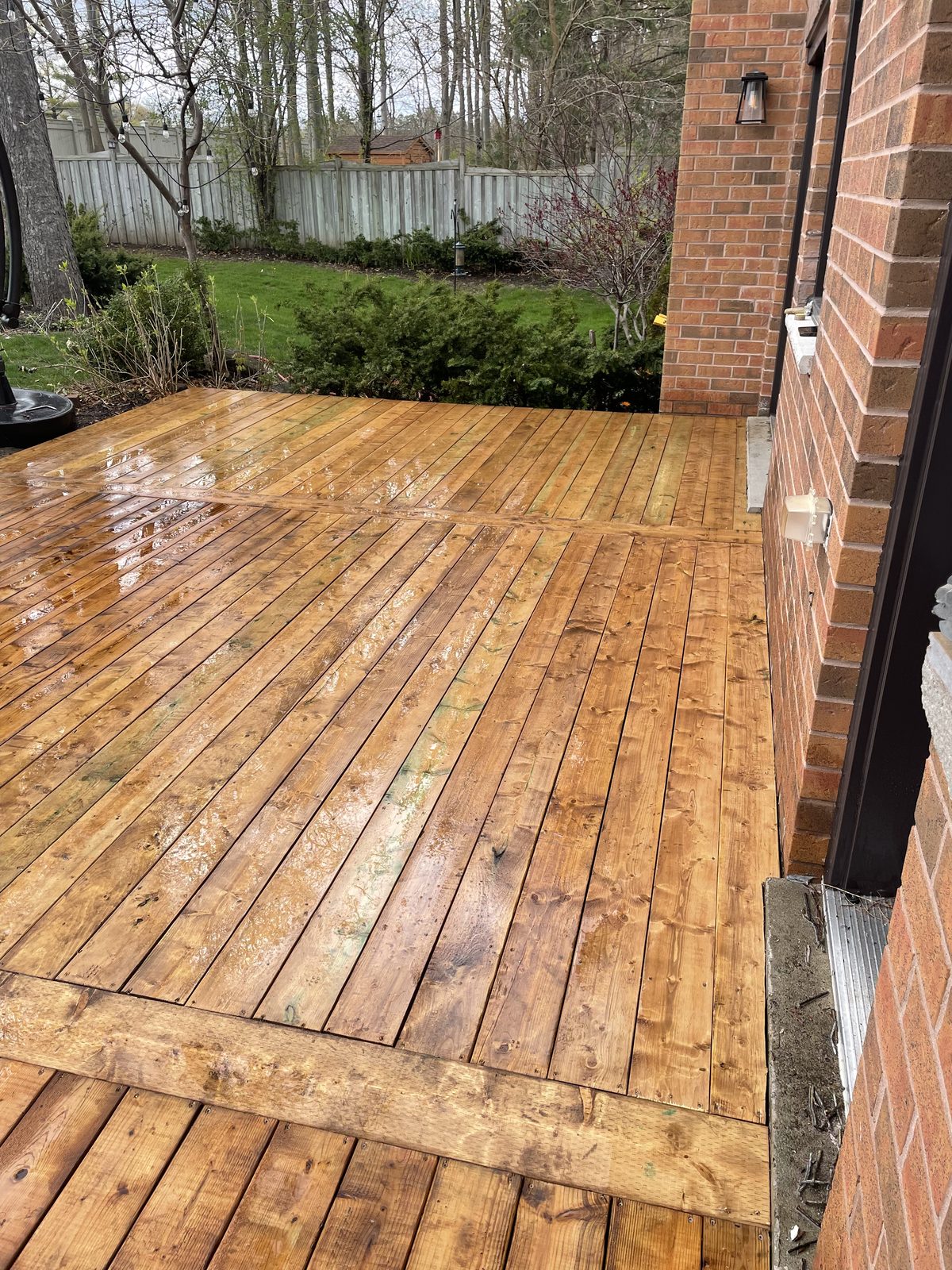 Freshly stained backyard deck — Pearl Improvements