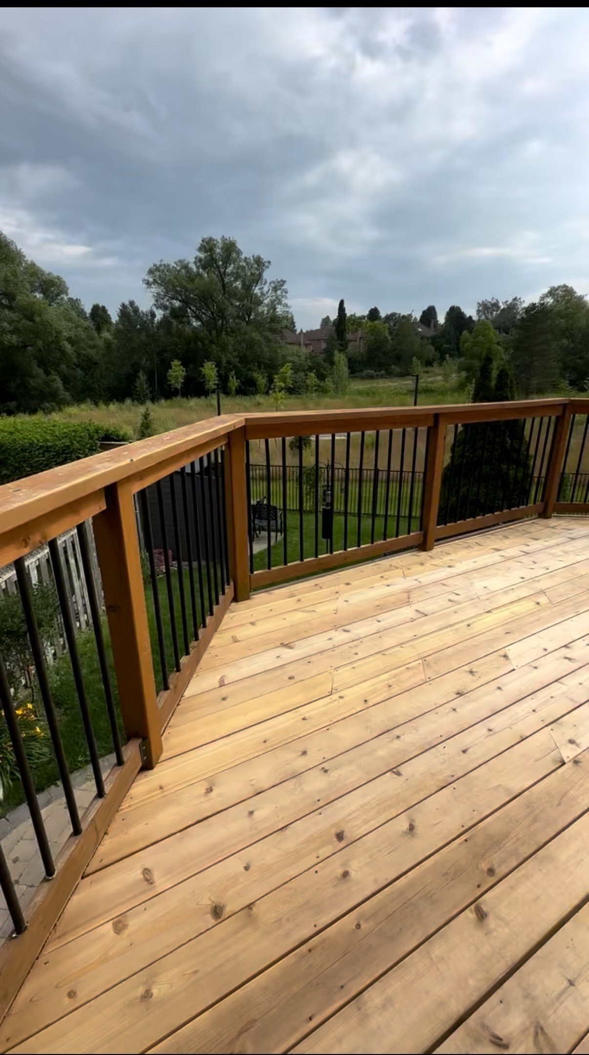 Hillside deck with railings and ravine view