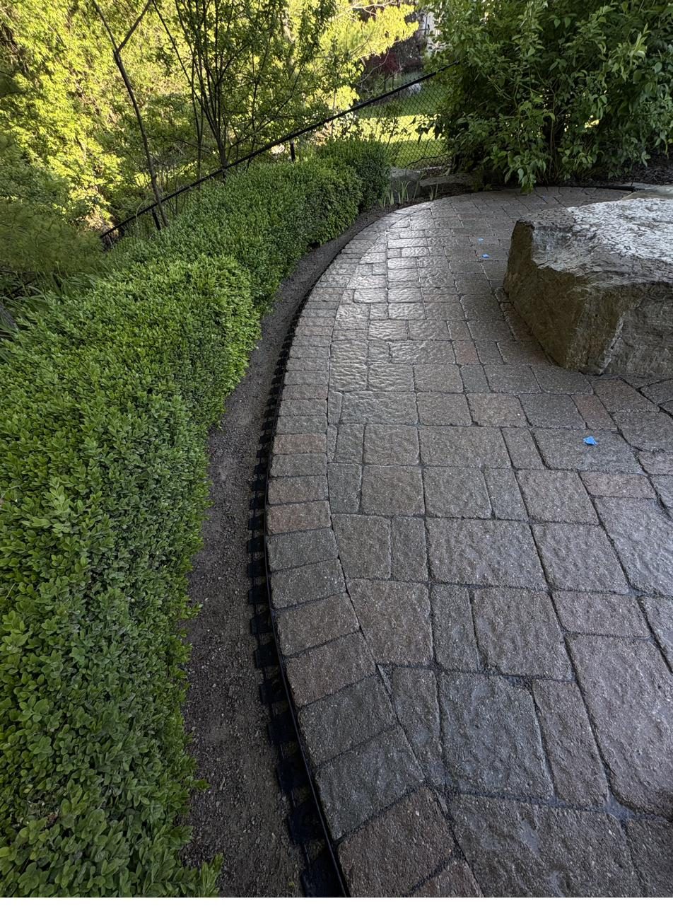 Curved interlock walkway with feature stone — Pearl Improvements