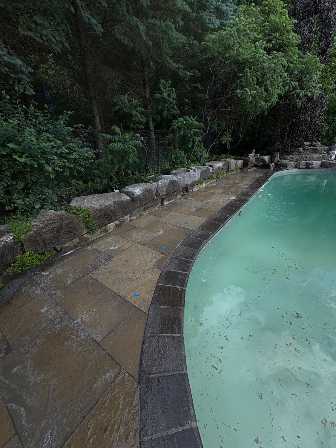 Pool-side slabs re-laid level and re-sanded