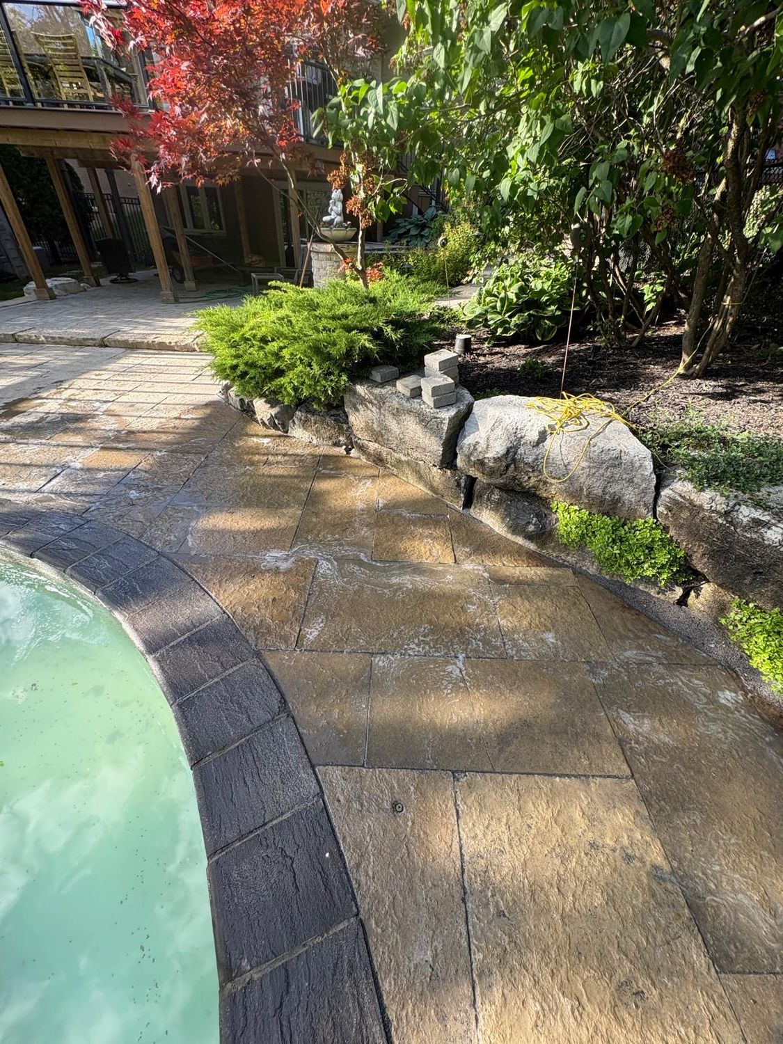 Pool-side slabs restored — re-laid level and re-sanded by Pearl Improvements